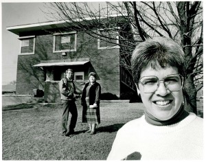Former CMC Executive Director, Sr. Shari Sutherland, RSM, in front of CMC's current building shortly after it was purchased in 1993. 