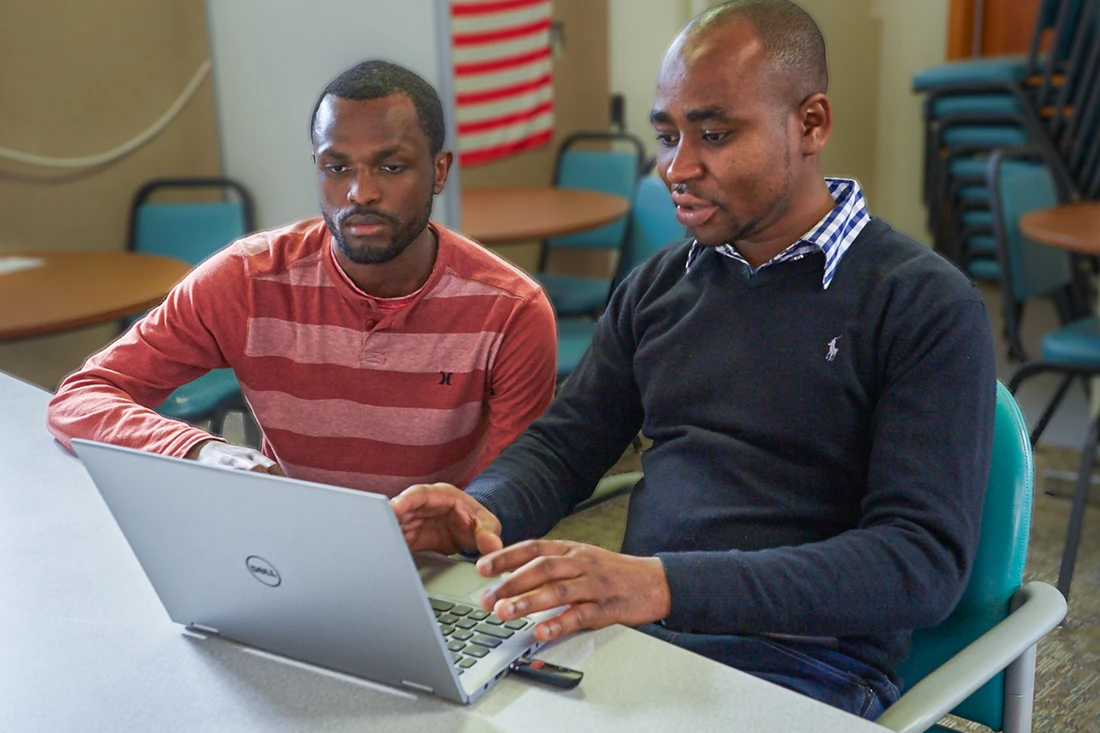 Two men working at a computer