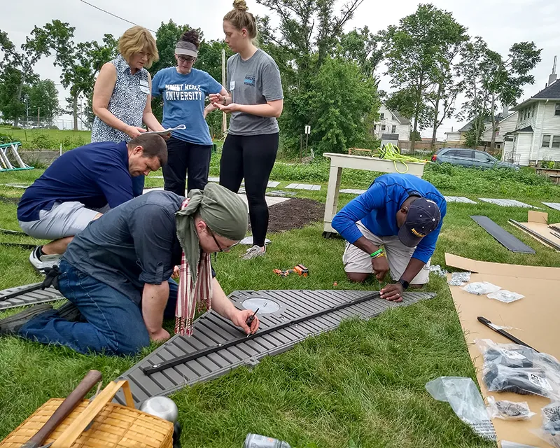 Volunteers building fence for Community Garden copy